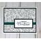 Merry Christmas card making kit with botanical scrapbook paper, black cardstock mat, stamped "Merry Christmas" sentiment and green ribbons.