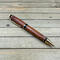 Gold plated pen with wood accents 