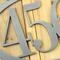 Close up of raw steel on our oval metal house number sign.