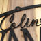 Close up of matte black powder coat on our first and last name oval metal sign.