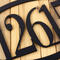 Close up of matte black powder coat on our oval metal house number sign.