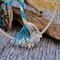 glass teardrop clear beads attached to lbue and white wire roots