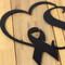 Close up of matte black powder coat on our breast cancer survivor metal sign.