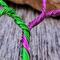 shown in hand to gauge 6 inch hoop size purple and green wire stand out against a grey background
