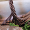 brown wire twisted into trunk and roots attached to grapevine wreath