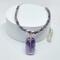 A handcrafted amethyst beaded necklace with a wire-wrapped pendant, silver-toned accents, and a steel chain, displayed on a white background