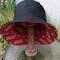 Front view of bucket hat on stand. Hat is reversed to show the black side, with the red and gold SF 49ers logos fabric underneath.