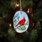 A hand-painted wood slice ornament featuring a brilliant red northern cardinal available at Cove Creek Photography.