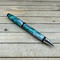 Green and silver cigar pen in chrome hardware
