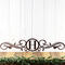 Metal monogram sign with vines, in copper vein powder coat.