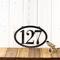 Horizontal oval 3 digit metal house number sign, in raw steel.