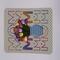 Green polka dot card featuring blue vase of tulips with the words MOM spelled out in rainbow colors over the design