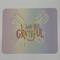 Watercolor backdrop featuring yellow striped bow with rainbow letters “I Am So Grateful”