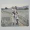 Mother’s Day card featuring scripture with mother in field holding 2 children boy and girl surrounded by yellow flowers and wooden fence