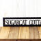 Close up of our hanging rectangular personalized lake house metal wall decor, in matte black powder coat.