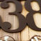 Close up of copper vein powder coat on our airplane house number sign.