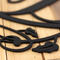Close up of matte black powder coat on our monogram metal sign with vines.