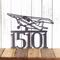 5 digit metal house number sign with airplane, in silver vein powder coat.