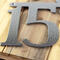 Close up of silver vein powder coat on our airplane house number sign.
