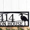 Close up of our custom metal address sign with great blue heron and sunset image, in matte black powder coat.