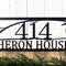 Close up of house numbers on our personalized metal address sign,with a great blue heron, in matte black powder coat.