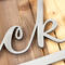 Close up of raw steel on our metal oval family sign with script font.