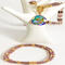 18-inch hand beaded necklace. Bead colors, gold, mauve, pale pink. A matching, fluid bangle is included that fits writs size 6 1/2 to 7 in.