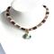 18-inch hand beaded necklace. Bead colors, gold, mauve, pale pink. A matching, fluid bangle is included that fits writs size 6 1/2 to 7 in.