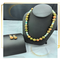 Agate stone with multiple colors. Gold spacers are used between each bead. The necklace is 20 inches long. Included are matching earrings.