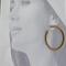 Model wearing Golden grass large hoop earrings