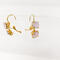 Double pale pink handset earrings in a gold color setting with the base metal of brass.