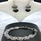 Agate stones of gray and black mixed with chain maille and a rhinestone-encrusted black toggle clasp. 