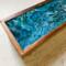 Bubbles and cells form on the design on top of this tea organizer.  Looks like waves in a turbulent ocean.