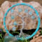 small tree of life made with aluminum wire to create the tree. It is adorned with 8mm light blue glass crackle beads