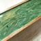 Close up of the green and gold design on top of this tea caddy large enough to sort up to 50 tea bags.