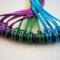 blue, purple, green, wire anchored to black silk wrapped 3 inch metal hoop