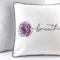 14" pillow embroidered with the word breathe as the stem of a purple rose stitched on white quilted fabric with black & white striped piping