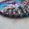 details shown of 8mm black frosted glass beads with blue and purple alunimum wire anchored to silk wrapped metal hoop