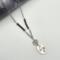 handcrafted necklace with textured pewter round and oval pendant, faceted garnet beads, and stainless steel chain