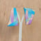 Asymmetrical earrings displayed on earring holder
