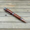 Cowboy boot, western star, and horseshoes on an antique copper ballpoint pen