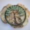 celtic style tree of life sits on a large chunk of quartz crystal