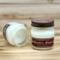 Pine and eucalyptus scented soy candle in 8oz mason jar. One jar standing up with lid on and one jar on its side with lid off.