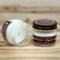 Fir tree scented soy candle in 4oz mason jar. One jar standing up with lid on and one jar on its side with lid off.