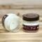 Banana bread scented soy candle in 4oz mason jar. One jar standing up with lid on and one jar on its side with lid off.