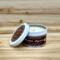 Fir tree scented soy candle in 6oz tin with lid off. 