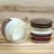 Apple cider scented soy candle in 4oz mason jar. One jar standing up with lid on and one jar on its side with lid off.