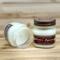 Fir tree scented soy candle in 8oz mason jar. One jar standing up with lid on and one jar on its side with lid off.
