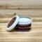 Apple cider scented soy candle in 6oz white tin with lid off.