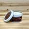 Gingerbread scented soy candle in 6oz tin with lid off.